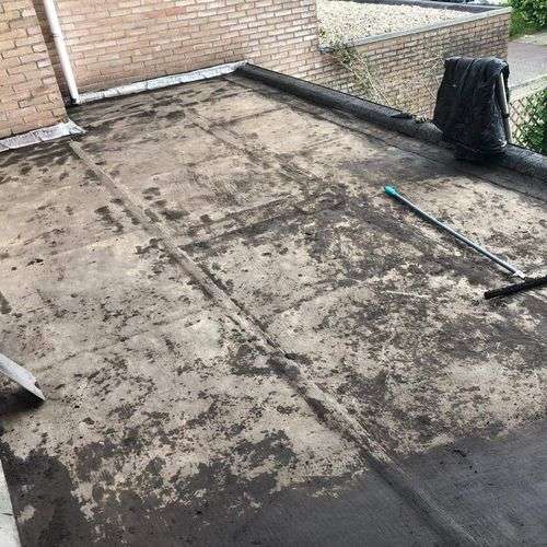 Schoonmaken van een plat dak in Wormerveer